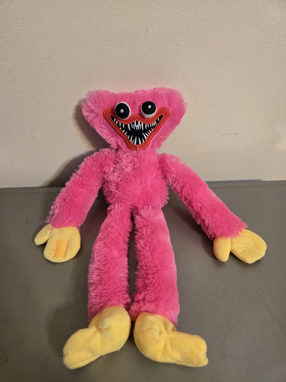 Pink Plush Monster Stuffed Animal with Yellow Hands and Feet